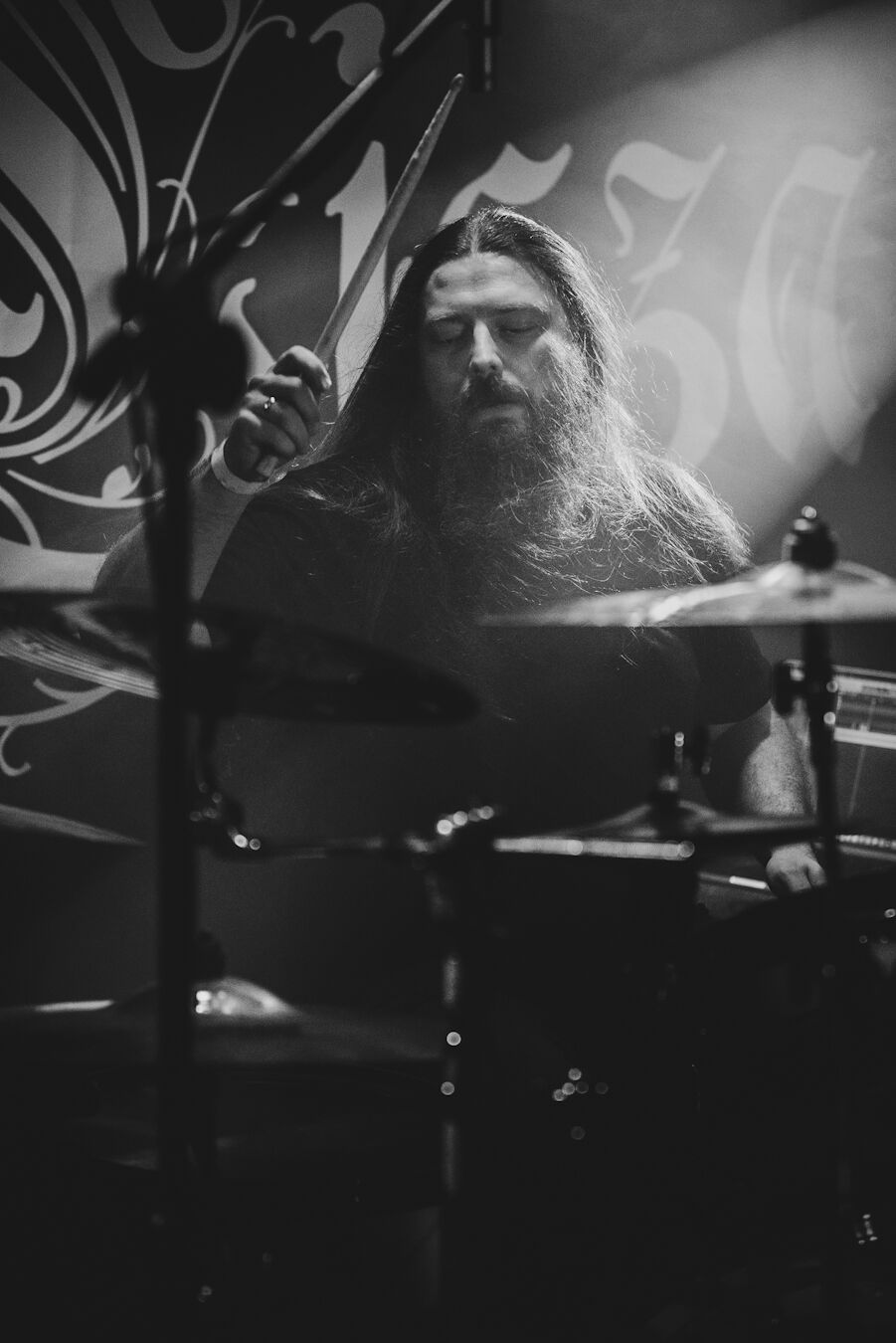 Drummer mid-strike in front of the CISZA backdrop