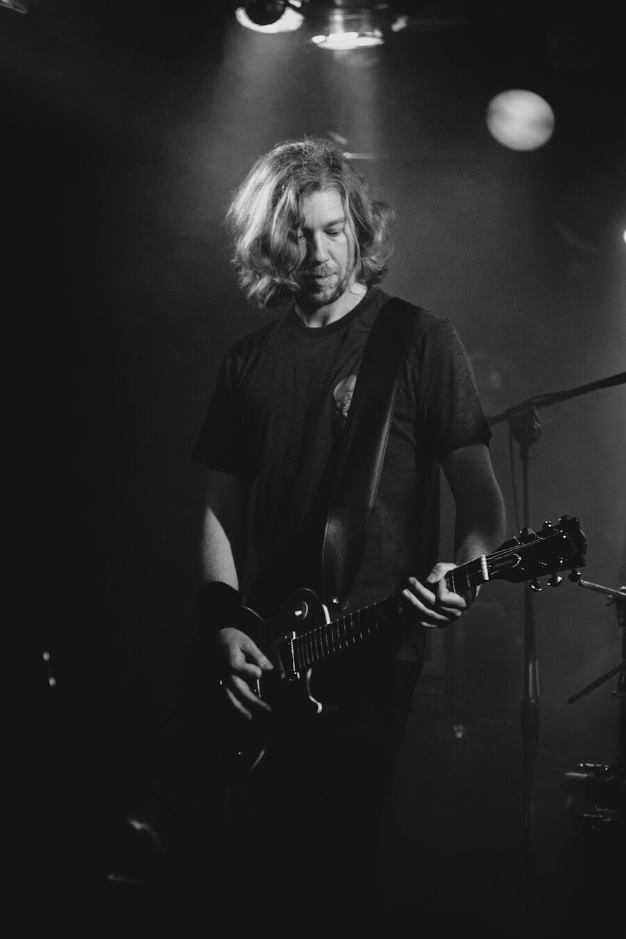 Guitarist bathed in smoke and backlight