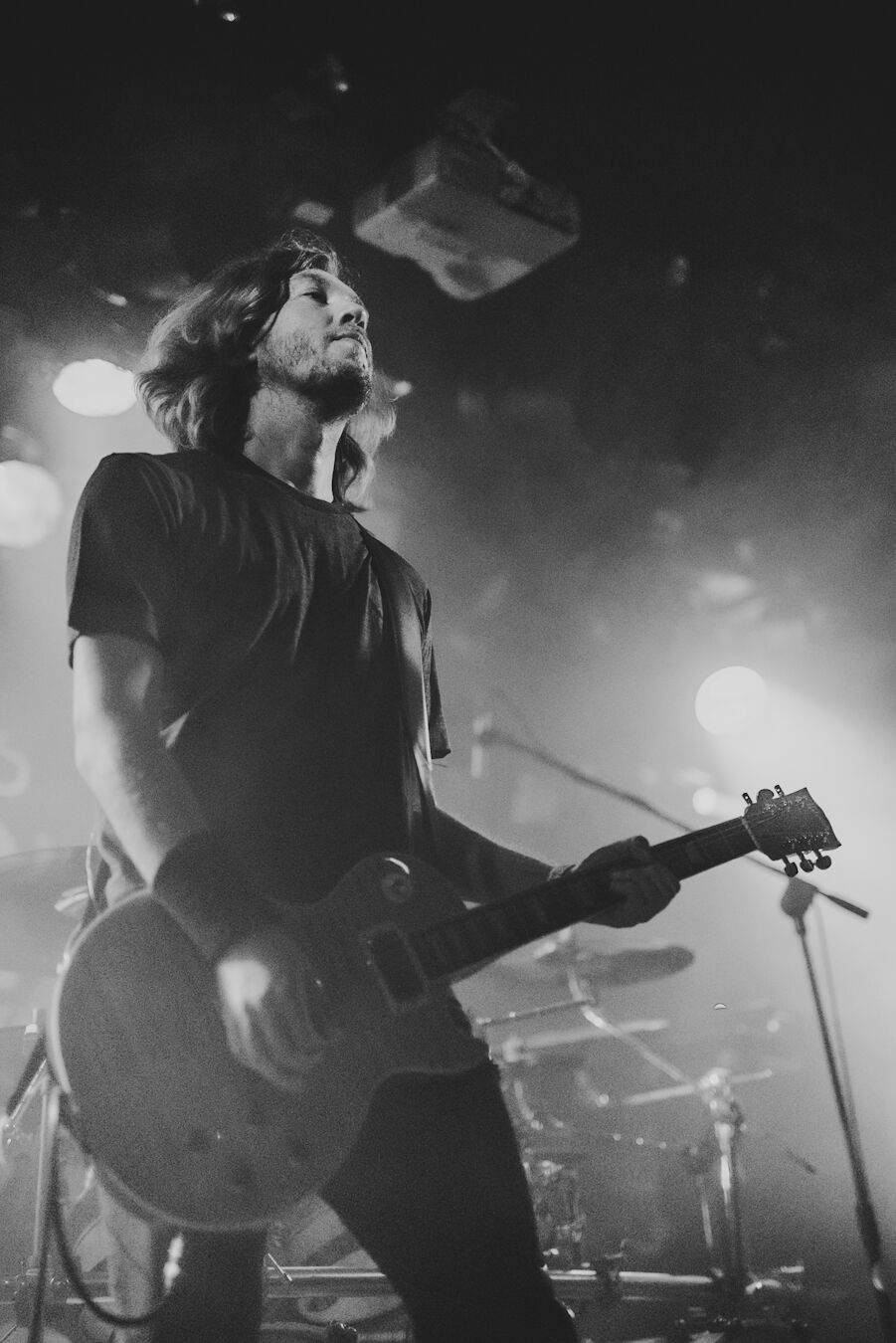 Guitarist shot from below against the stage lights